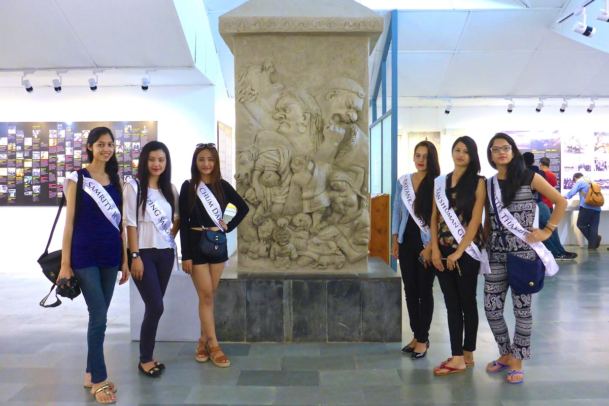 Pageant contestants pose with the memorial for the deceased Tibetans as a result of the Chinese occupation.