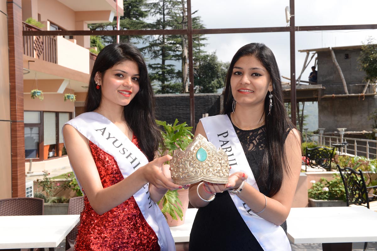 The two contestants for the Miss Himalaya Pageant 2016, Ayushi Sethi and Parul Patel, hold the crown of the Pageant during a press conference in McLeod Ganj, India, on 8 October 2016.